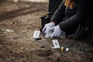 Woman collecting crime scene evidence